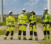 Four Employees Wearing High-Visibility PPE
